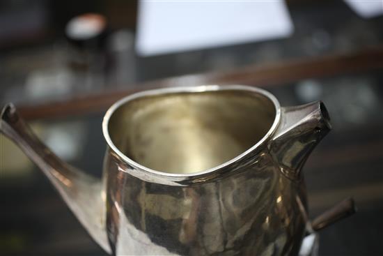 A stylish 1970s silver four piece tea set with tea strainer by Graham Watling of Lacock, gross 51 oz.